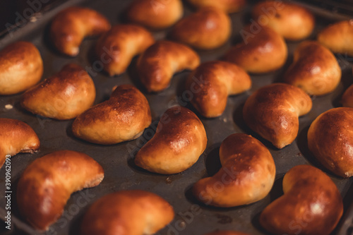 Traditional Latvian homemade yeast dough patties with bacon. Fresh baked pies or patties, closeup.