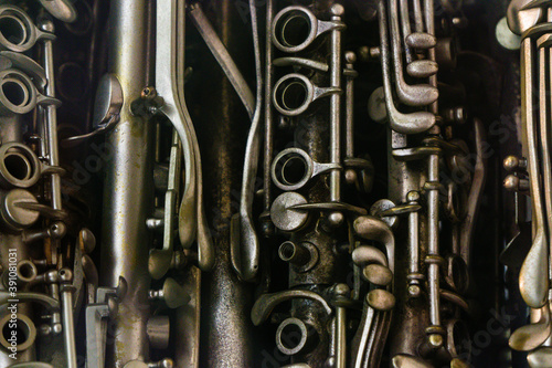 Closeup of musical woodwind instruments like flutes clarinets 