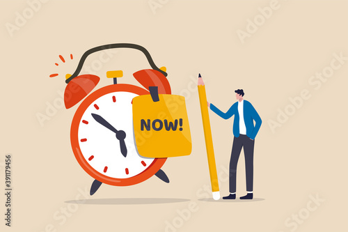 Stop procrastination, do it now or decision to finish work or appointment in time concept, confidence businessman holding pencil after he wrote the word Now on note and stick it on ringing alarm clock