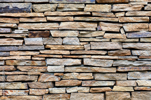 Sandstone stone wall mosaic, texture and background.
