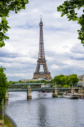 Eiffel tower on the background of the river Seine surrounded by leaves. Paris. France.