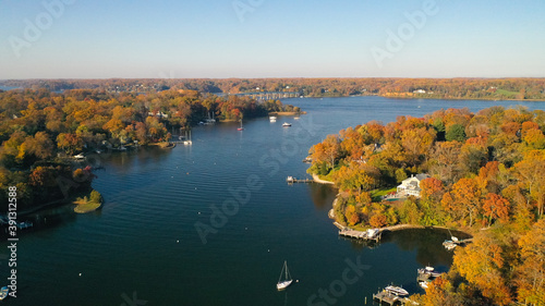 Aerial view of colorful sailboat moorings, docks, and bright golden foliage on Weems Creek, in historic downtown Annapolis Maryland on a fall day