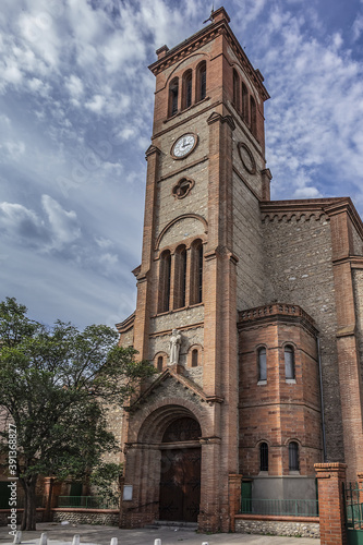 Gothic style Catholic parish Saint Joseph Church. Like other monuments of city - statue of Saint Joseph located on its porch, as well as its bells are oldest in Perpignan. Pyrenees Orientales, France.