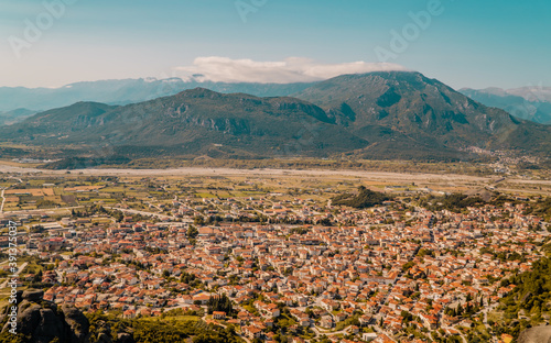 Aerial panoramic sunset view of the town of Kalambaka with mountains in the background in the Meteora region in Thessaly, Greece