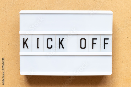 Lightbox with word kick off on wood background