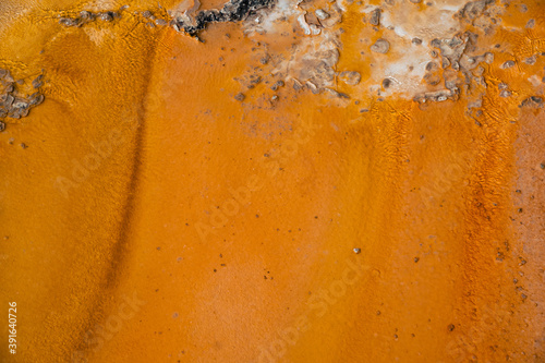 Abstract view of orange minerals of a hot spring geyser thermal feature in Yellowstone National Park. Useful for backgrounds