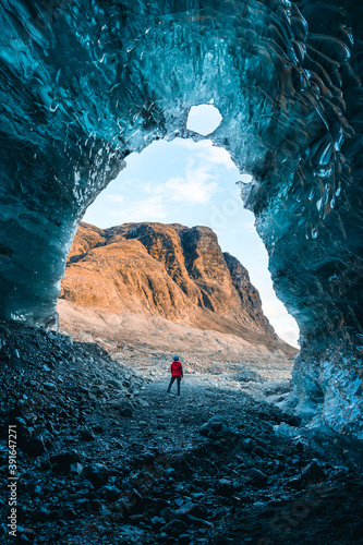 Solo female adventure traveler is discovering the ice caves in Iceland at Vatnajokull Glacier near to Jokulsarlon Glacier Lagoon. Tourism in abandoned Iceland . Outdoor living and exploring 