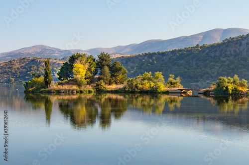 Trees are reflecting at the calm waters of koutavos lagoon near Argostoli in Kefalonia, Greece 