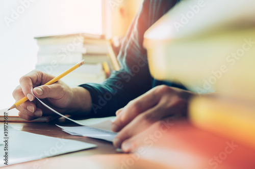 high school,university student study.hands holding pencil writing paper answer sheet.sitting lecture chair taking final exam attending in examination classroom.concept scholarship for education abroad