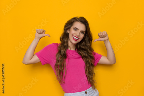 Confident Young Woman Is Pointing At Herself With Thumbs