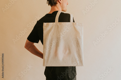 Back view man carrying tote bag