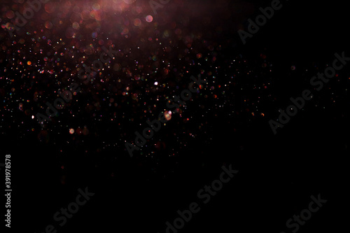 Festive glitter black and colourful lighting background. Shimmery colourful waterdrops for Chiristmas desing