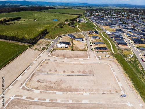 Aerial shots of a developing housing estate in the outer suburbs of Melbourne Australia, roads and gutters have been built, plots of land some already sold are almost ready for houses to be built.