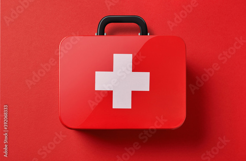 First aid kit on red background