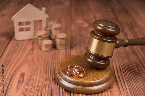 Divorce property division concept. Judge hammer, home and coin money. Court law