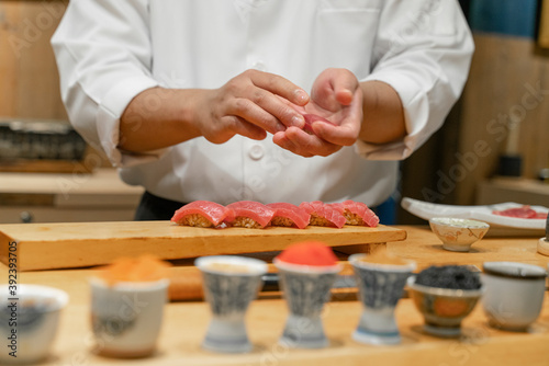 Japanese Sushi Chef making Blue Fin Tuna Sushi. Omakase sushi course.