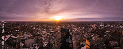 Looking into rising sun from Lexington, Kentucky downtown district with silhouette projections of tall office buildings