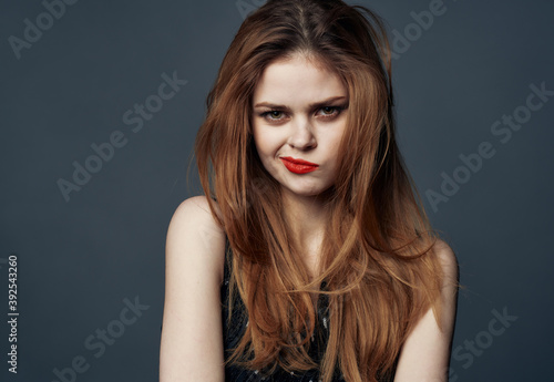 Portrait of red-haired woman with red lips emotions model gray background