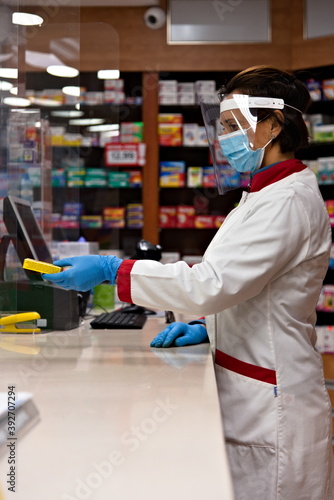 Pharmacist dispensing drugs in a pharmacy.