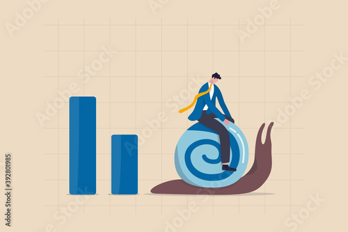 World economic slow down due to COVID-19 Coronavirus pandemic, GDP growth slowly or decline in recession concept, depressed sad businessman riding slow walking snail on economic graph and chart.
