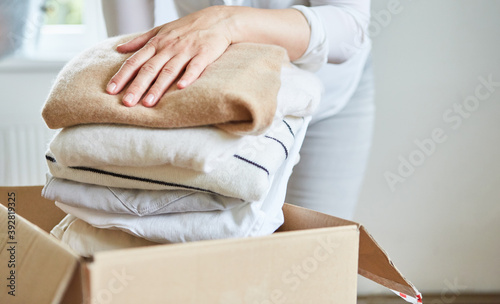 Woman packs clothes for a clothing donation