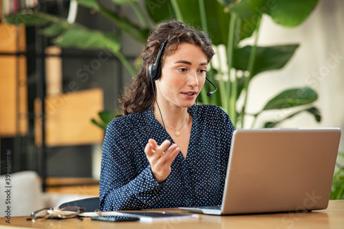 Young woman on video call using laptop at office