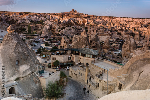 Beautiful landscape of Goreme and Uchisar castle at distance on sunrise.Cappadocia.Turkey. View of rock formations fairy chimneys, hotels and houses at the cave. Top attraction travel destinations.