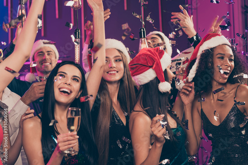Photo of careless people party girl hold glass golden wine having fun wear stylish outfit santa claus cap modern club indoors