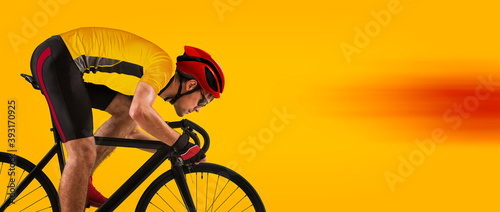 Man racing cyclist on yellow background. Man in yellow cycling jersey