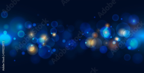 Abstract bokeh light on dark blue background. 