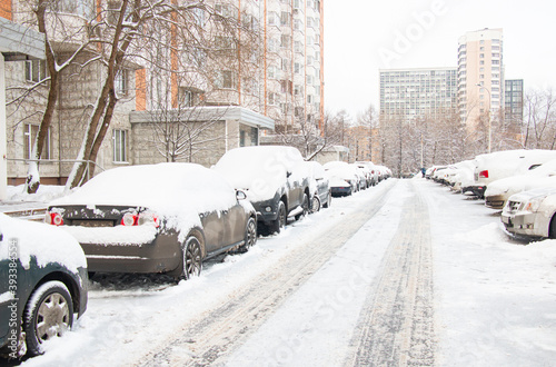 Snow-covered cars in the city after a snowfall