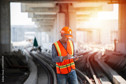 A railway worker inspecting a railroad wagon during a scheduled maintenance inspection. engineer under inspection and checking construction process railway switch and check