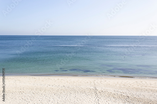 Abstract calm blue sea water horizon with light sand beach and sky wild nature beauty 