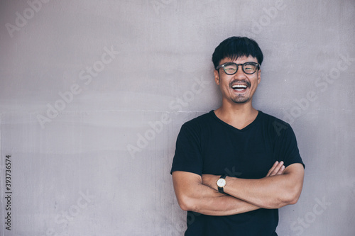 portrait young asian man wear eye glasses smiling cheerful look thinking position with perfect clean skin posing on background.fashion people freedom life style concept