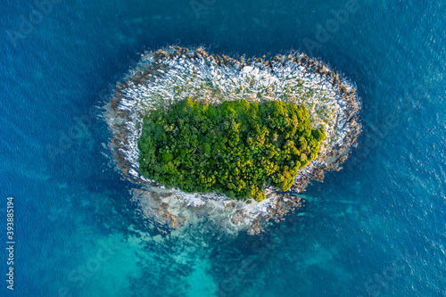Heart shaped island on the Adriatic sea seen from birds eye perspective.