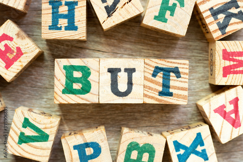 Alphabet letter block in word but with another on wood background