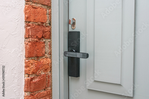 White door to the house, door handle, close up