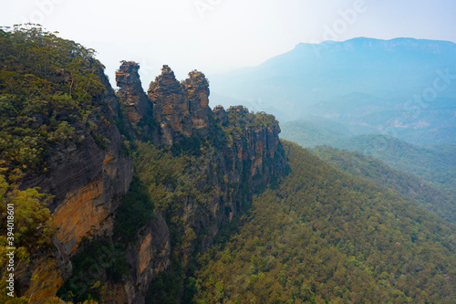 The three sisters rock formation with forest fire smoke in the background, Blue Mountains, New South Wales