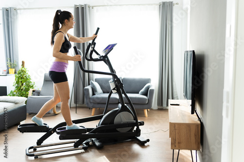 Woman Training On Elliptical Trainer Online