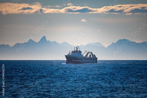 fishing vessel in front of mountain background