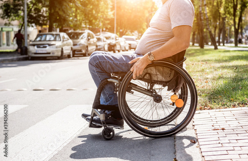 Handicapped man in wheelchair crossing street road