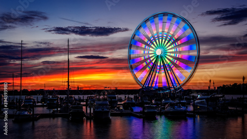 Illuminated Capital Wheel ferris ride at National Harbor near Washington DC at sunset