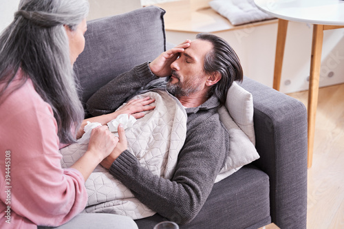 Woman sitting near her senior sick husband