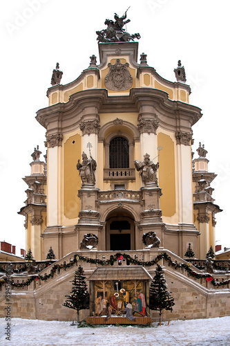 Winter view of Cathedral of St. Yura in Lviv on Christmas holidays with traditional Christmas nativity scene in the foreground.