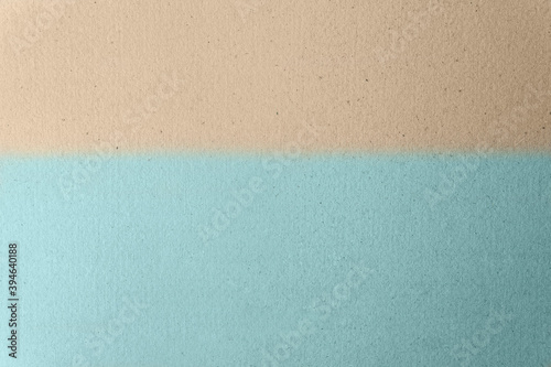 Sandy Light brown split with soft light blue on craft cardboard box paper background. Beach scene concept