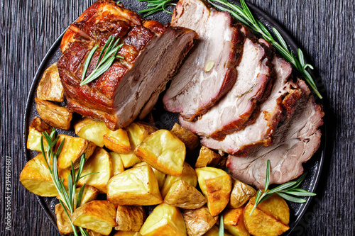 Whole roasted pork loin with baked potato wedges