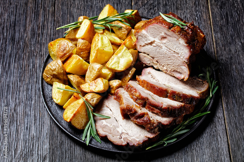 Whole roasted pork loin with baked potato wedges