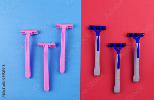 Gender stereotypes on the example of razors. Pink shaving razors on a blue background, blue shaving razors on a pink background
