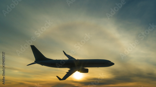 Silhouette of a flying plane on the background of a beautiful sunset. Airline concept, travel tourism, flight. copy space