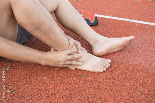 man ankle injury after running at Running field
